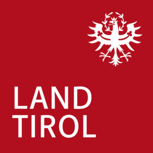 Offizielles Logo „Land Tirol“. Weißer Tiroler Adler und Schriftzug auf rotem Hintergrund.